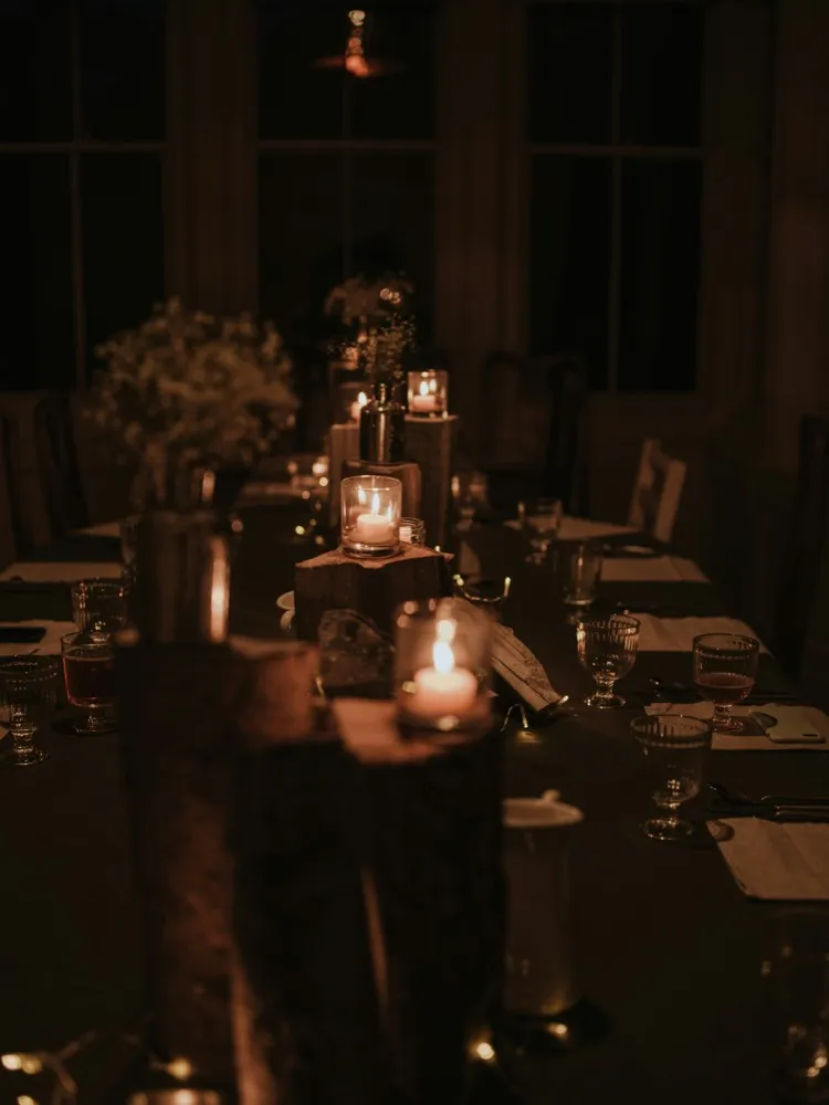 Moody candlelit long dinner table