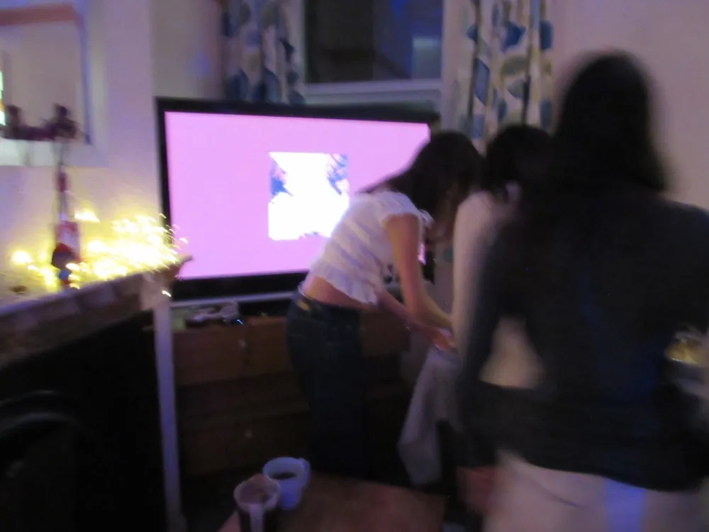 Dancing at a house party with fairy lights
